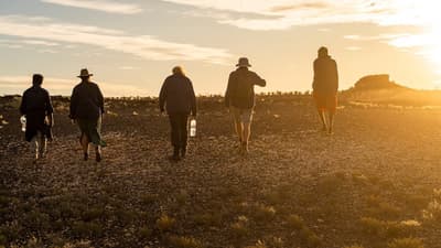 Several people walking away into the sunset at Pullen Pullen Reserve.